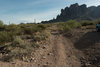 Small parking area with rocks blocking the road ahead.
